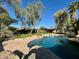 Beautiful backyard pool with lush landscaping and mature trees, perfect for outdoor entertaining at 11021 N 74Th St, Scottsdale, AZ 85260