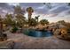 Beautiful backyard pool with rock features and lush landscaping, perfect for relaxation at 11021 N 74Th St, Scottsdale, AZ 85260