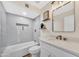 Bathroom features new lighting, white cabinetry and tub with shower at 1108 E Villa Rita Dr, Phoenix, AZ 85022