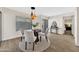 Cozy dining area featuring a modern round table, stylish lighting, and easy access to the outdoors at 1108 E Villa Rita Dr, Phoenix, AZ 85022
