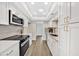 Open kitchen boasts updated appliances, white cabinetry, and quartz countertops at 1108 E Villa Rita Dr, Phoenix, AZ 85022
