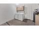 Functional laundry room with washer, dryer, and storage cabinets, offering convenience and organization at 1108 E Villa Rita Dr, Phoenix, AZ 85022
