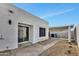 Outdoor patio space with modern stucco, a sliding glass door, and a rock garden, providing a serene retreat at 1108 E Villa Rita Dr, Phoenix, AZ 85022