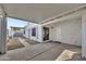 Cozy covered patio with sliding glass doors, white walls and concrete pavers. Gravel landscaping adds texture at 1108 E Villa Rita Dr, Phoenix, AZ 85022