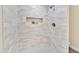 Walk-in shower boasts gray and white tile and a built-in shelf at 1108 E Villa Rita Dr, Phoenix, AZ 85022