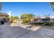 Spacious backyard with a pool, trampoline, lush landscaping, and a concrete patio at 11933 N 140Th Ln, Surprise, AZ 85379