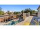 Balcony view featuring railing overlooking a pool with nearby palm trees and city views at 11933 N 140Th Ln, Surprise, AZ 85379