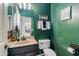 Stylish half bathroom with a green textured wall and a dark vanity with a stone countertop at 11933 N 140Th Ln, Surprise, AZ 85379