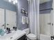Stylishly updated bathroom with modern fixtures, a vanity, a decorative mirror, and a shower-tub combo at 11933 N 140Th Ln, Surprise, AZ 85379