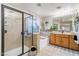 Well-appointed bathroom with a glass-enclosed shower, soaking tub, and stylish vanity with ample storage at 11933 N 140Th Ln, Surprise, AZ 85379