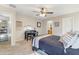 Bedroom features neutral walls, desk, ceiling fan, and decor, creating a cozy, personalized space at 11933 N 140Th Ln, Surprise, AZ 85379