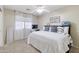 Bright bedroom features plush carpet, a ceiling fan, and natural light from a window with sheer white curtains at 11933 N 140Th Ln, Surprise, AZ 85379