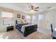 Bedroom boasts carpeted floors, a ceiling fan, and windows providing ample natural light and ventilation at 11933 N 140Th Ln, Surprise, AZ 85379
