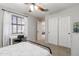Light-filled bedroom with a ceiling fan, window with blinds, and a desk for a functional workspace at 11933 N 140Th Ln, Surprise, AZ 85379