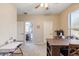 Bonus room with natural light, a table with chairs, and a view into the attached bathroom at 11933 N 140Th Ln, Surprise, AZ 85379