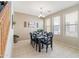 Inviting dining space with neutral decor, large windows, and a contemporary table set for eight at 11933 N 140Th Ln, Surprise, AZ 85379