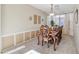 Formal dining room boasts elegant wood table and chairs, accented by stylish decor and natural light at 11933 N 140Th Ln, Surprise, AZ 85379