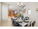 Open-concept dining area with modern table and seating, seamlessly connected to the kitchen and staircase at 11933 N 140Th Ln, Surprise, AZ 85379