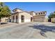 Spacious home with a large driveway and an attached three-car garage at 11933 N 140Th Ln, Surprise, AZ 85379