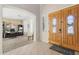 Elegant foyer with a wood double-door entrance and a view into the office at 11933 N 140Th Ln, Surprise, AZ 85379