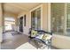 Charming front porch with a bench, decorative pillows, and a welcoming entrance at 11933 N 140Th Ln, Surprise, AZ 85379