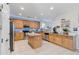 Well-lit kitchen featuring wood cabinets, stainless steel appliances, granite countertops, and an island at 11933 N 140Th Ln, Surprise, AZ 85379