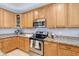 Well-appointed kitchen featuring granite countertops, stainless steel appliances, and wood cabinetry at 11933 N 140Th Ln, Surprise, AZ 85379
