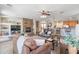 Inviting living room with stone fireplace, comfortable seating, and an open layout to the kitchen at 11933 N 140Th Ln, Surprise, AZ 85379