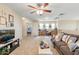 Upstairs living room with a ceiling fan, comfortable seating, and a dedicated workspace for added functionality at 11933 N 140Th Ln, Surprise, AZ 85379