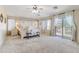 Spacious main bedroom featuring a luxurious bed, bench, and ample natural light from surrounding windows at 11933 N 140Th Ln, Surprise, AZ 85379
