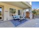 Cozy covered patio with comfortable seating, stylish decor, and a view of the backyard at 11933 N 140Th Ln, Surprise, AZ 85379
