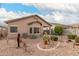 A wide shot of the backyard with desert landscaping, built-in barbeque and covered patio at 12814 W Sells Dr, Litchfield Park, AZ 85340