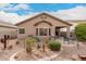 View of the home's backyard, featuring desert landscaping, a covered patio and a built-in barbeque at 12814 W Sells Dr, Litchfield Park, AZ 85340