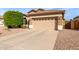 Home exterior featuring a two car garage, desert landscaping and barrel tile roof at 12814 W Sells Dr, Litchfield Park, AZ 85340