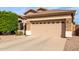 Home exterior featuring a two car garage, desert landscaping and barrel tile roof at 12814 W Sells Dr, Litchfield Park, AZ 85340