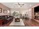Cozy living room with hardwood floors, ceiling fan, and sliding door access to the backyard at 12814 W Sells Dr, Litchfield Park, AZ 85340