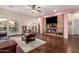 Open-concept living room featuring a media center, fireplace and access to the outdoor living space at 12814 W Sells Dr, Litchfield Park, AZ 85340