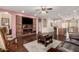 Spacious living room showcasing built-in shelving, fireplace, hardwood flooring and backyard access at 12814 W Sells Dr, Litchfield Park, AZ 85340