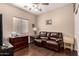 Comfortable living room with a plush leather sofa and dark wood flooring at 12814 W Sells Dr, Litchfield Park, AZ 85340