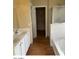 Bathroom featuring double sinks, a soaking tub, and a walk-in closet at 14930 N Gil Balcome Ct, Surprise, AZ 85379