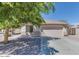 Charming single-story home with a well-maintained front yard and a two car garage at 14930 N Gil Balcome Ct, Surprise, AZ 85379