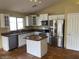 Well-appointed kitchen featuring white cabinets, stainless steel appliances, and a center island at 14930 N Gil Balcome Ct, Surprise, AZ 85379
