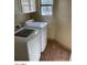This laundry room features a washer and dryer, white cabinets, and tiled floors at 14930 N Gil Balcome Ct, Surprise, AZ 85379