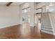 Spacious living room featuring wood floors, vaulted ceiling, and an open staircase at 1655 W Meseto Cir, Mesa, AZ 85202