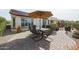 A beautifully landscaped backyard featuring an outdoor dining area under an umbrella, surrounded by lush desert plants at 16712 S 175Th Ln, Goodyear, AZ 85338