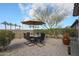 Picturesque backyard featuring a charming patio, comfortable seating, and mature desert landscaping at 16712 S 175Th Ln, Goodyear, AZ 85338