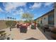 A cozy backyard with a stylish patio, comfortable seating around a fire pit, and mature landscaping at 16712 S 175Th Ln, Goodyear, AZ 85338