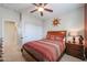 Comfortable bedroom with a ceiling fan, sunburst wall art, and carpeted floors at 16712 S 175Th Ln, Goodyear, AZ 85338