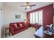 Stylish den featuring a comfortable sofa, ceiling fan and plantation shutters at 16712 S 175Th Ln, Goodyear, AZ 85338