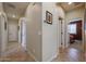 Hallway with neutral walls, tiled floors, and multiple doors to various rooms in the home at 16712 S 175Th Ln, Goodyear, AZ 85338